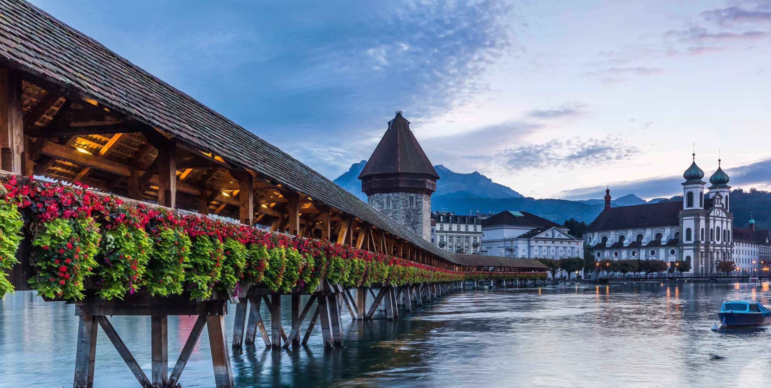 Chapel Bridge across lake Lucerne with the Jesuit church on the banks of the lake