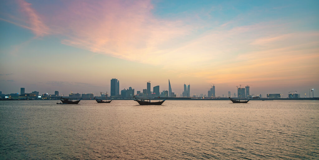 Manama Skyline Panorama - typical bahrain boats anchored in the sea