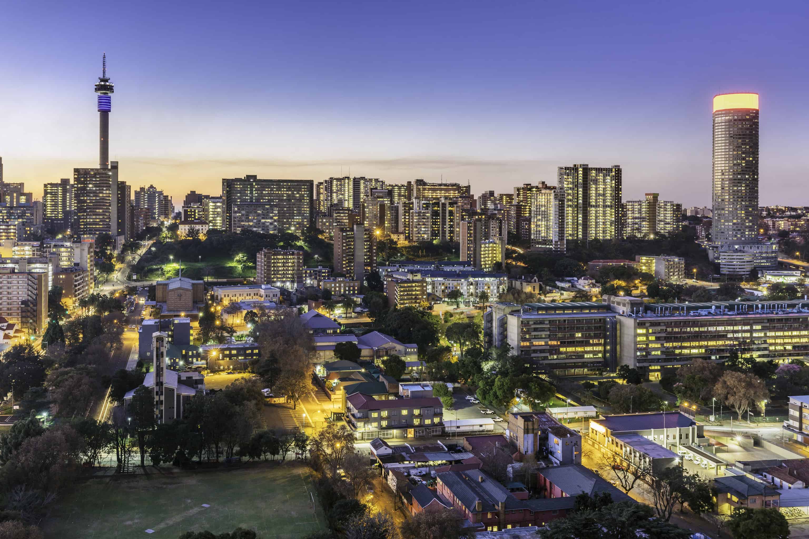 Johannesburg cityscape panorama sunset with the residential hillbrow suburb and the iconic Telkom communication tower to Ponte tower. Johannesburg is one of the forty largest metropolitan cities in the world, and the world's largest city that is not situated on a river, lakeside, or coastline. It is also the source of a large-scale gold and diamond trade, due being situated in the mineral-rich Gauteng province.