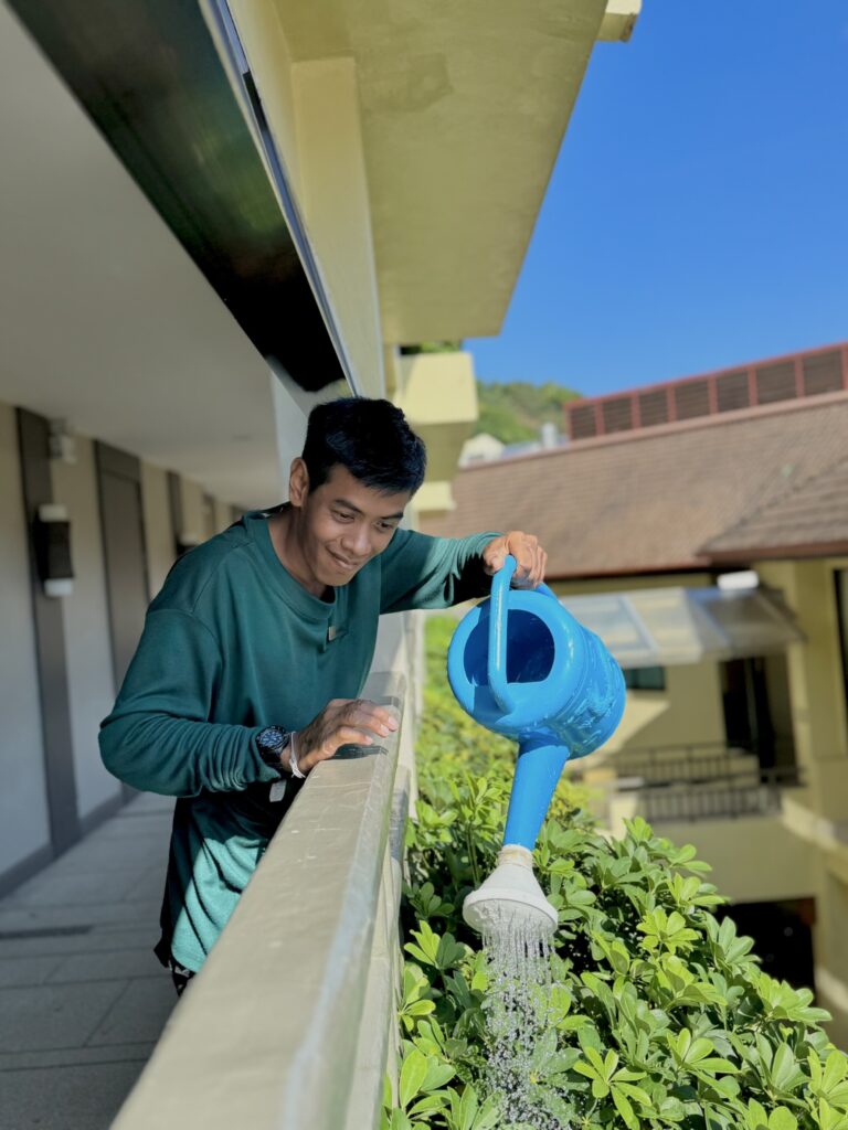 An associate with disability watering plants