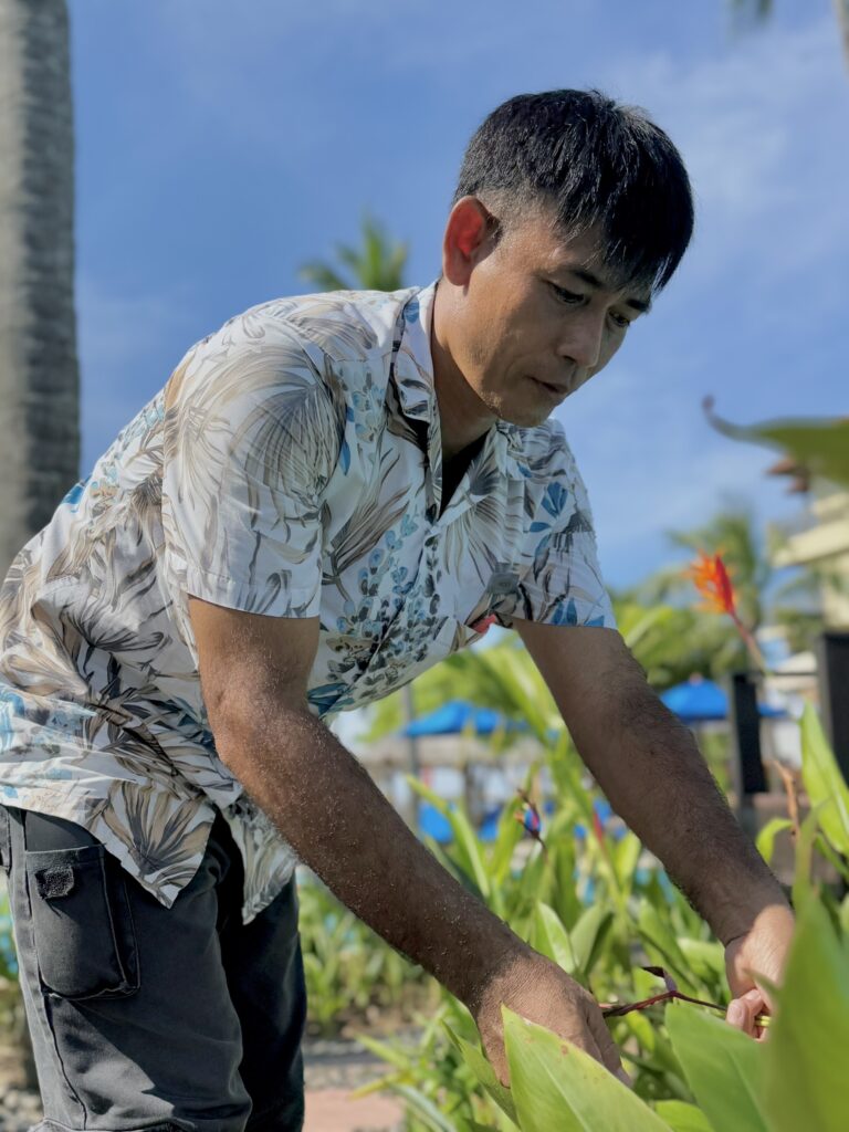 A gardening supervisor tending to the hotel's landscaping