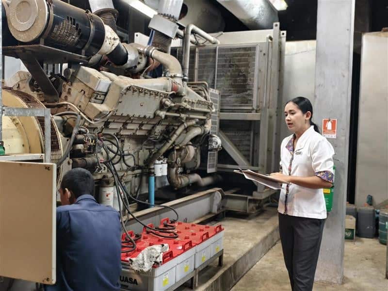 Khun Bo guiding her technical team at work.