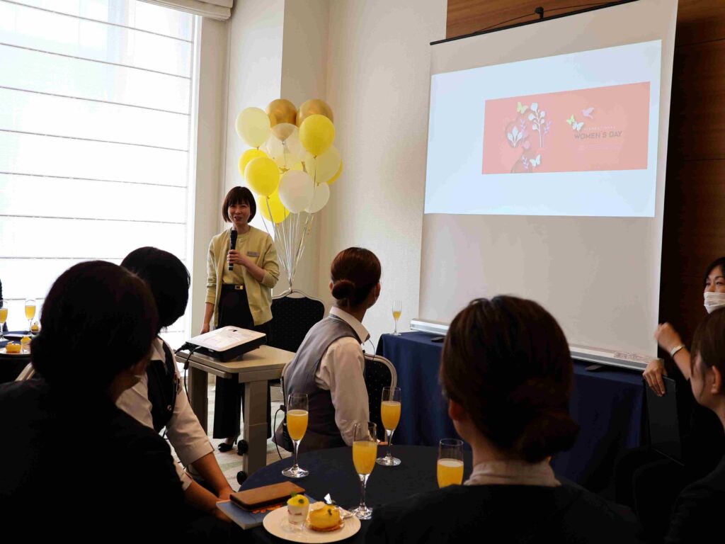 A Director of Sales & Marketing hosting a Women's Day dialogue with associates.