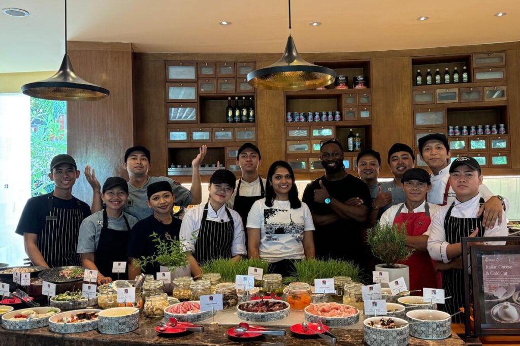 Roomila and her team stand proudly before the elaborate spread.