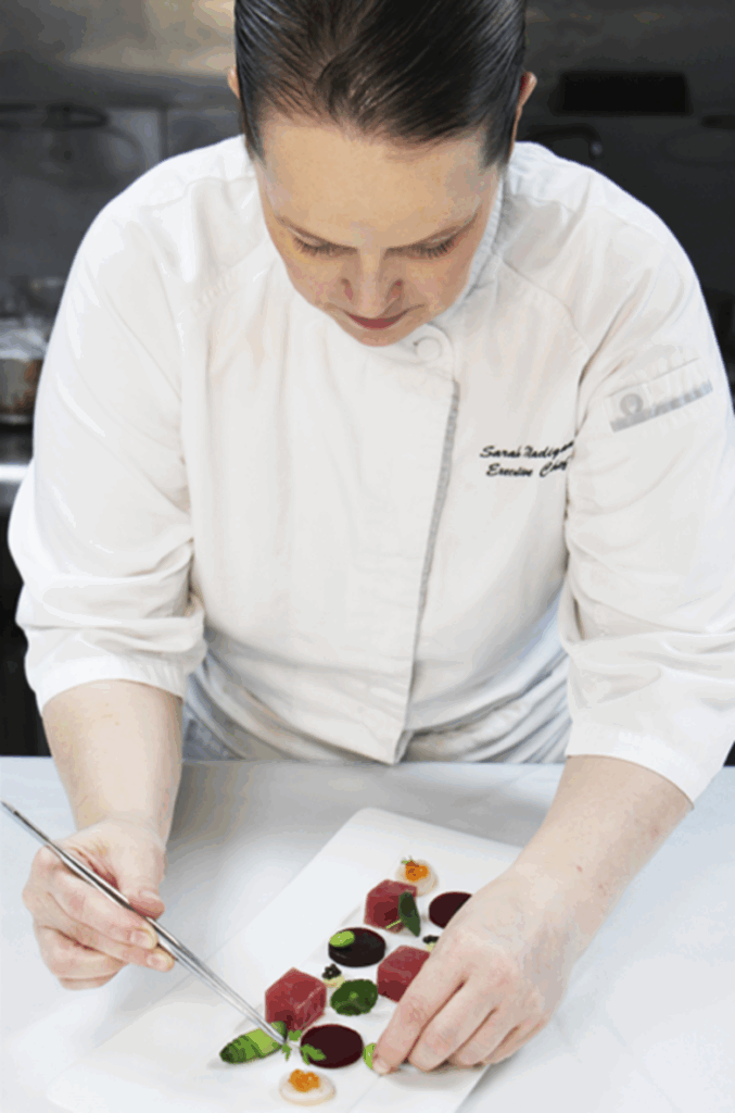 Chef Sarah artfully plating her culinary creations.